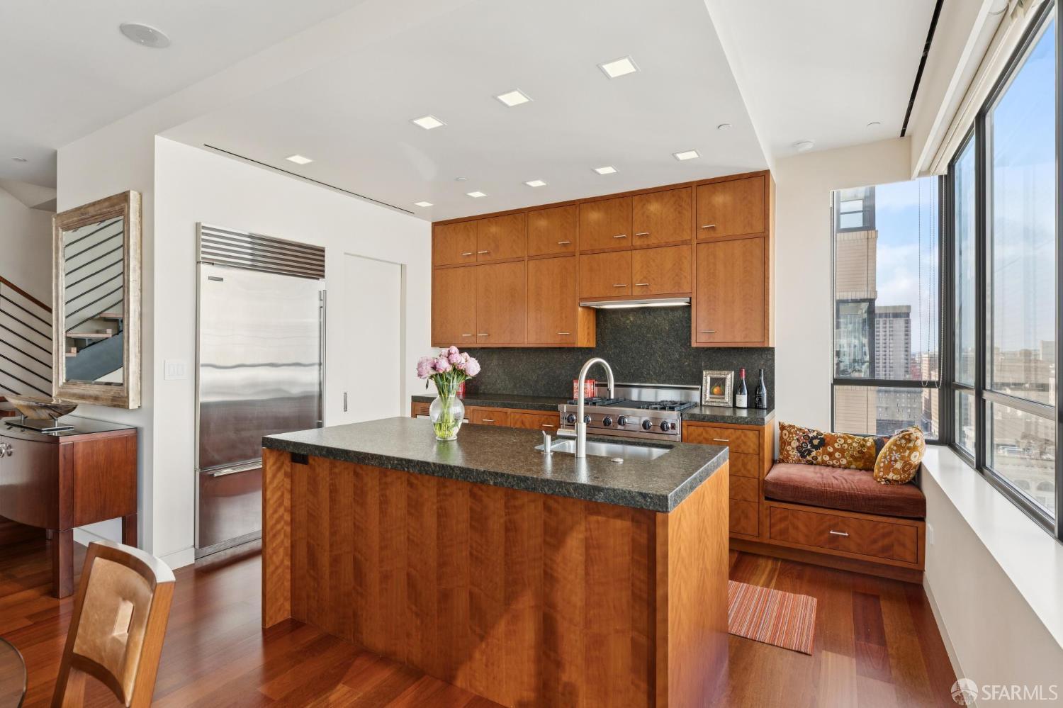 690 Market Street, Unit 2404 San Francisco, CA 94104 - Photo 13 of 36 a kitchen with stainless steel appliances granite countertop sink stove and cabinets