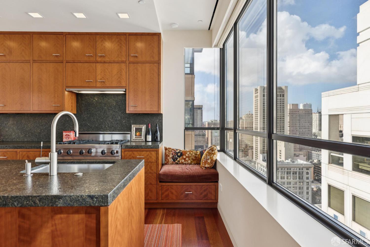 690 Market Street, Unit 2404 San Francisco, CA 94104 - Photo 14 of 36 a kitchen with stainless steel appliances granite countertop a sink and a large window