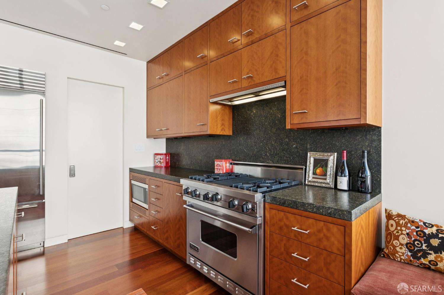 690 Market Street, Unit 2404 San Francisco, CA 94104 - Photo 15 of 36 a kitchen with stainless steel appliances granite countertop a stove a sink and a refrigerator