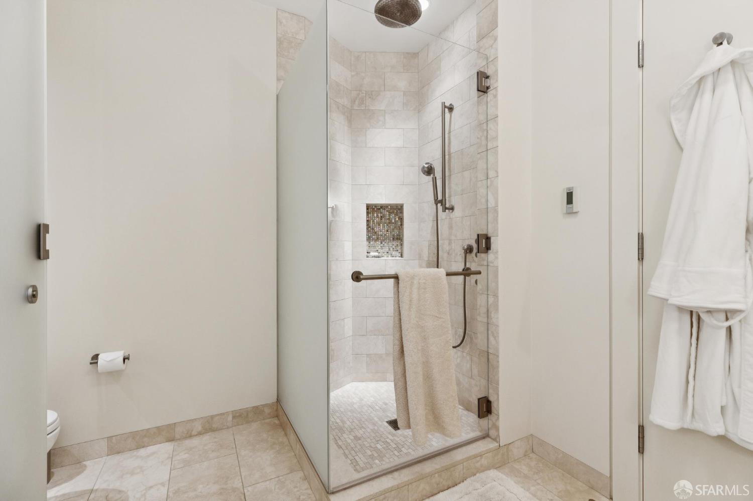 690 Market Street, Unit 2404 San Francisco, CA 94104 - Photo 21 of 36 a bathroom with a glass shower door