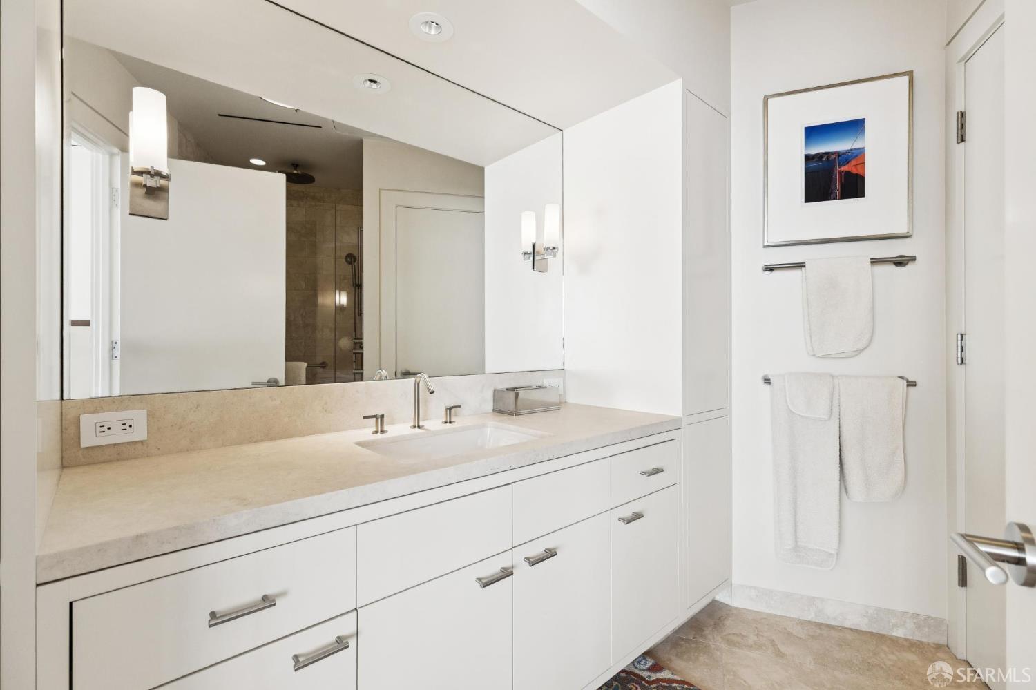 690 Market Street, Unit 2404 San Francisco, CA 94104 - Photo 25 of 36 a bathroom with a shower sink and mirror