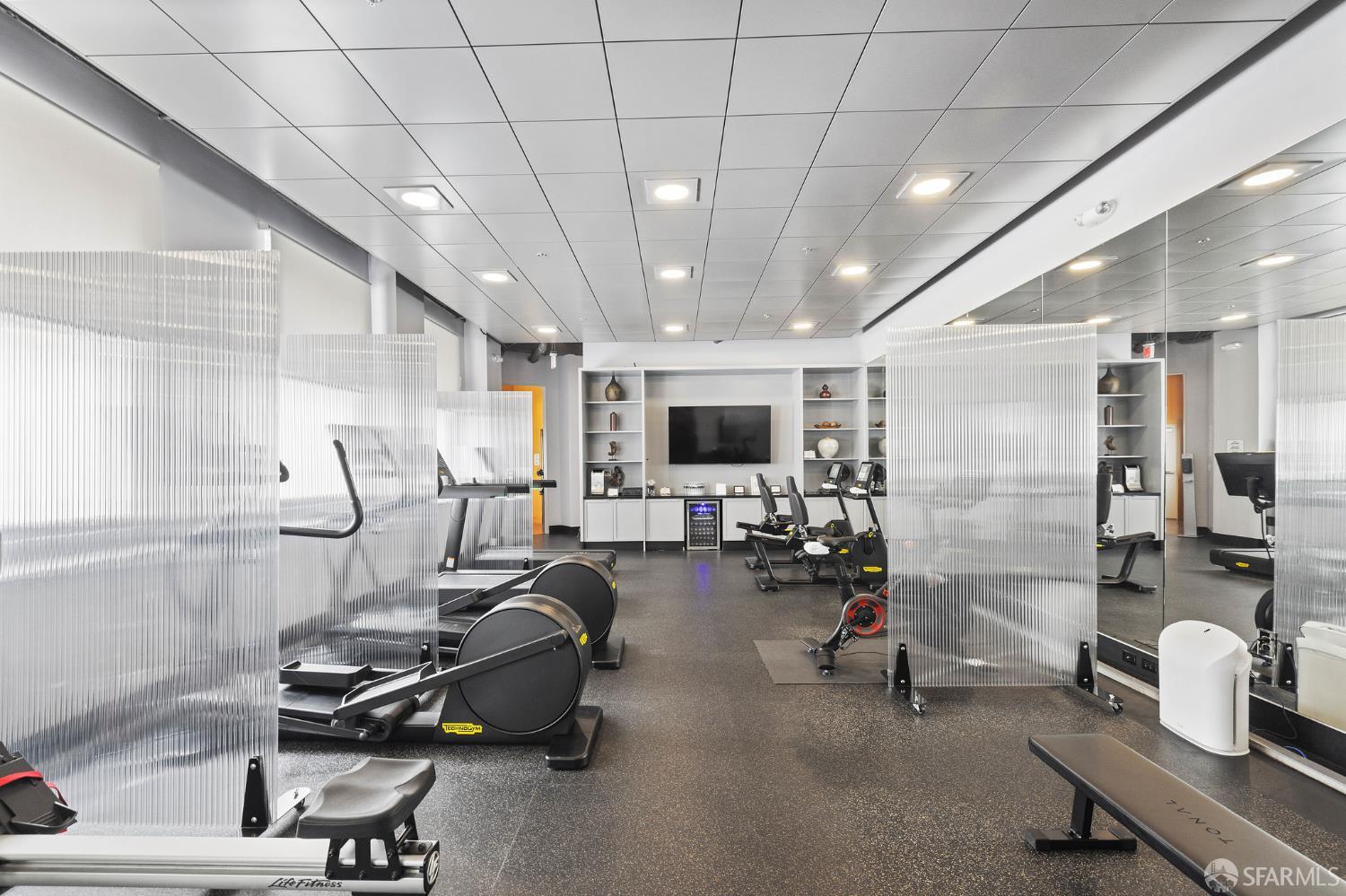 690 Market Street, Unit 2404 San Francisco, CA 94104 - Photo 35 of 36 a room with gym equipment and a large window