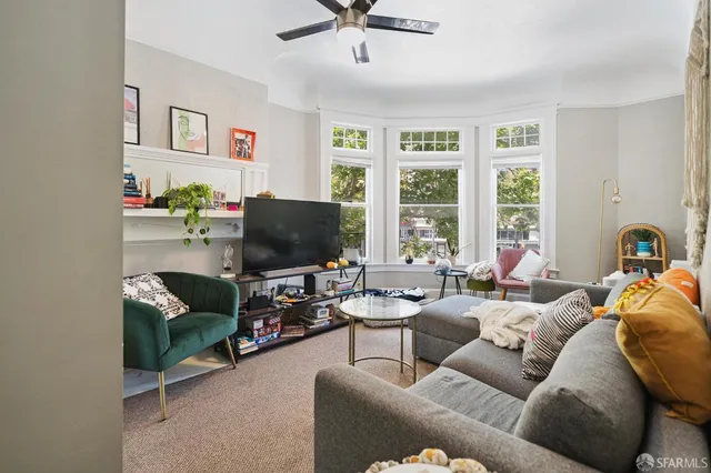 a front view of a house with a tree