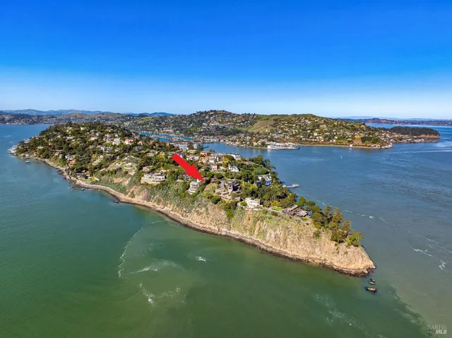 a view of a lake with lawn chairs
