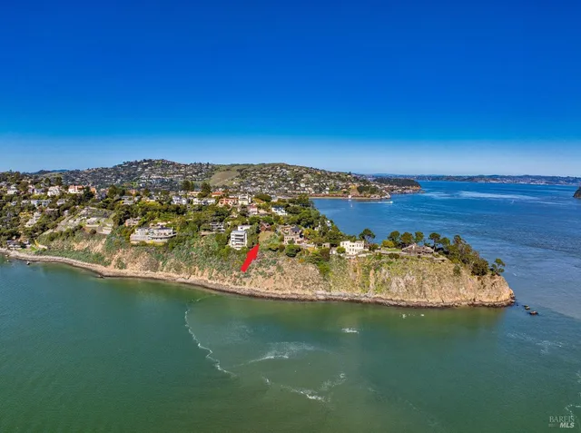 an aerial view of a house with a garden and lake view