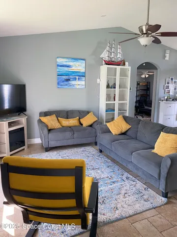 a living room with furniture and a flat screen tv