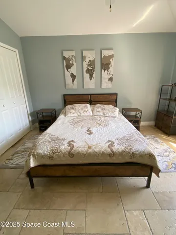 a bedroom with a bed and wall painting