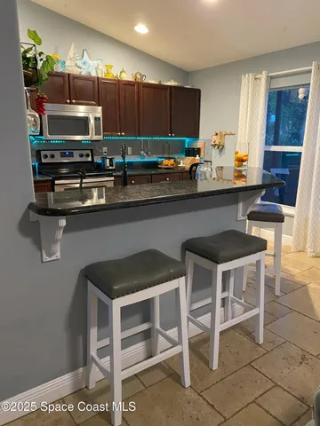 a kitchen with a table chairs and a refrigerator