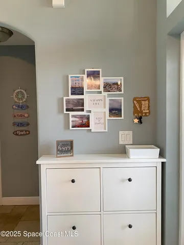 a view of a bathroom with cabinet and mirror