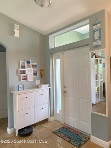 a dining room with furniture a chandelier and wooden floor