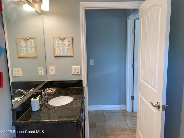 a bathroom with a sink a toilet and shower curtain