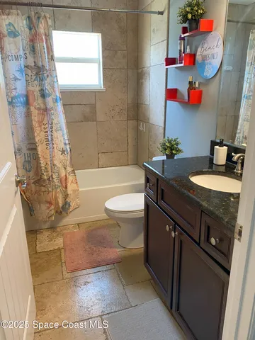 a living room with lots of furniture and a window