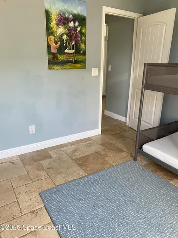 a view of a livingroom with furniture and a flat screen tv