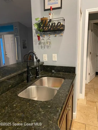 a kitchen with a sink and a stove top oven