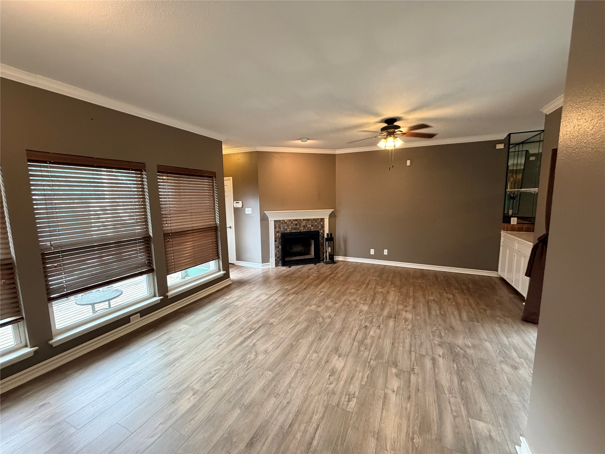 6600 Valleyside Road, Unit D20 Austin, TX 78731 - Photo 11 of 14 The open-concept living area features warm wood-look flooring and a cozy corner fireplace.