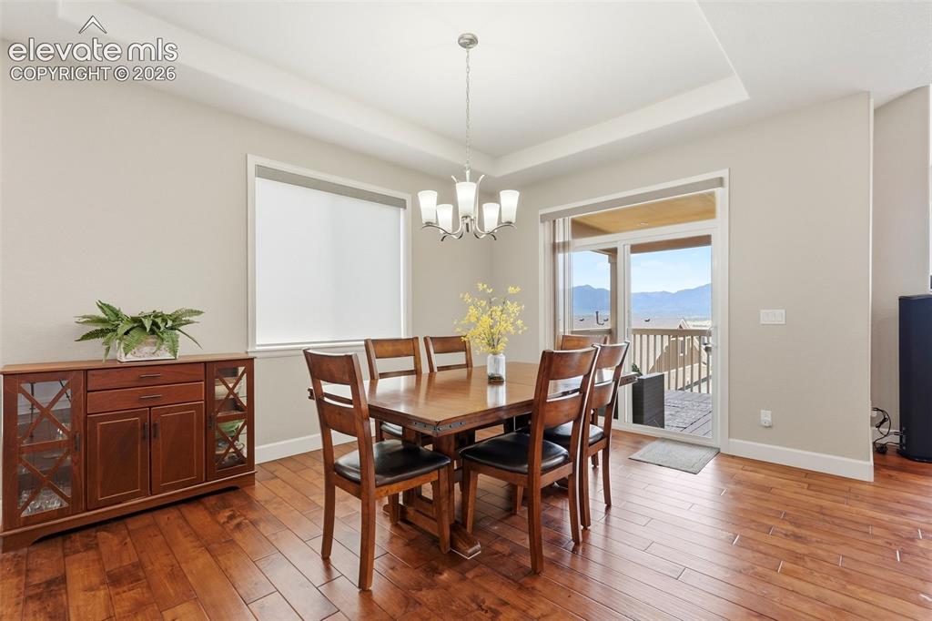 1394 Promontory Bluff View Colorado Springs, CO 80921 - Photo 3 of 47 a view of a dining room with furniture window and wooden floor