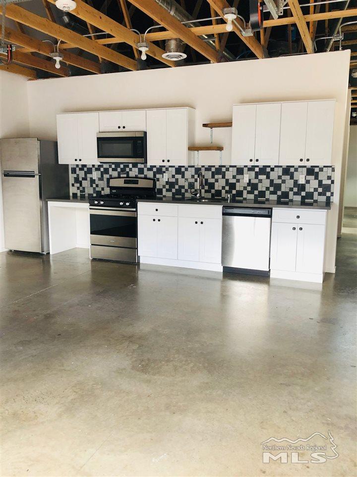 339 South Wells Avenue Reno, NV 89502 - Photo 19 of 20 a kitchen with stainless steel appliances a white stove top oven and cabinets