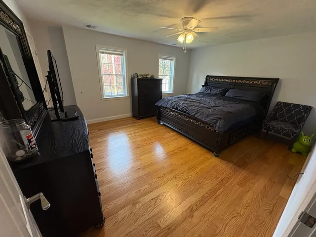 a bedroom with a bed dresser and a window