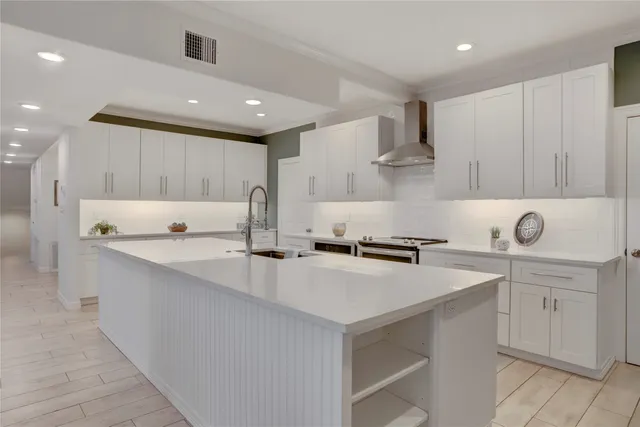 a kitchen with a sink a stove and cabinets