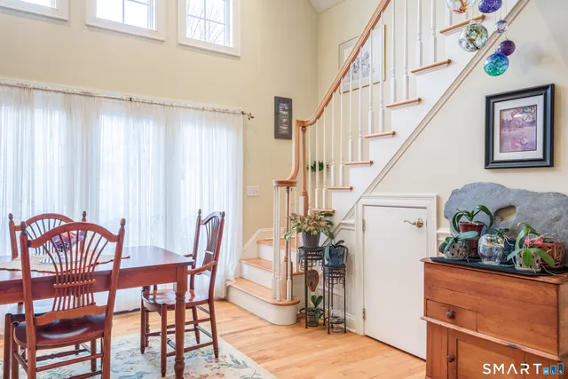 a bathroom with a glass shower door and a wooden floor
