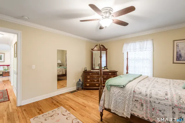a bathroom with a toilet a sink and a window