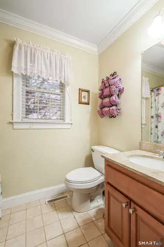 a living room with furniture a flat screen tv and a large window
