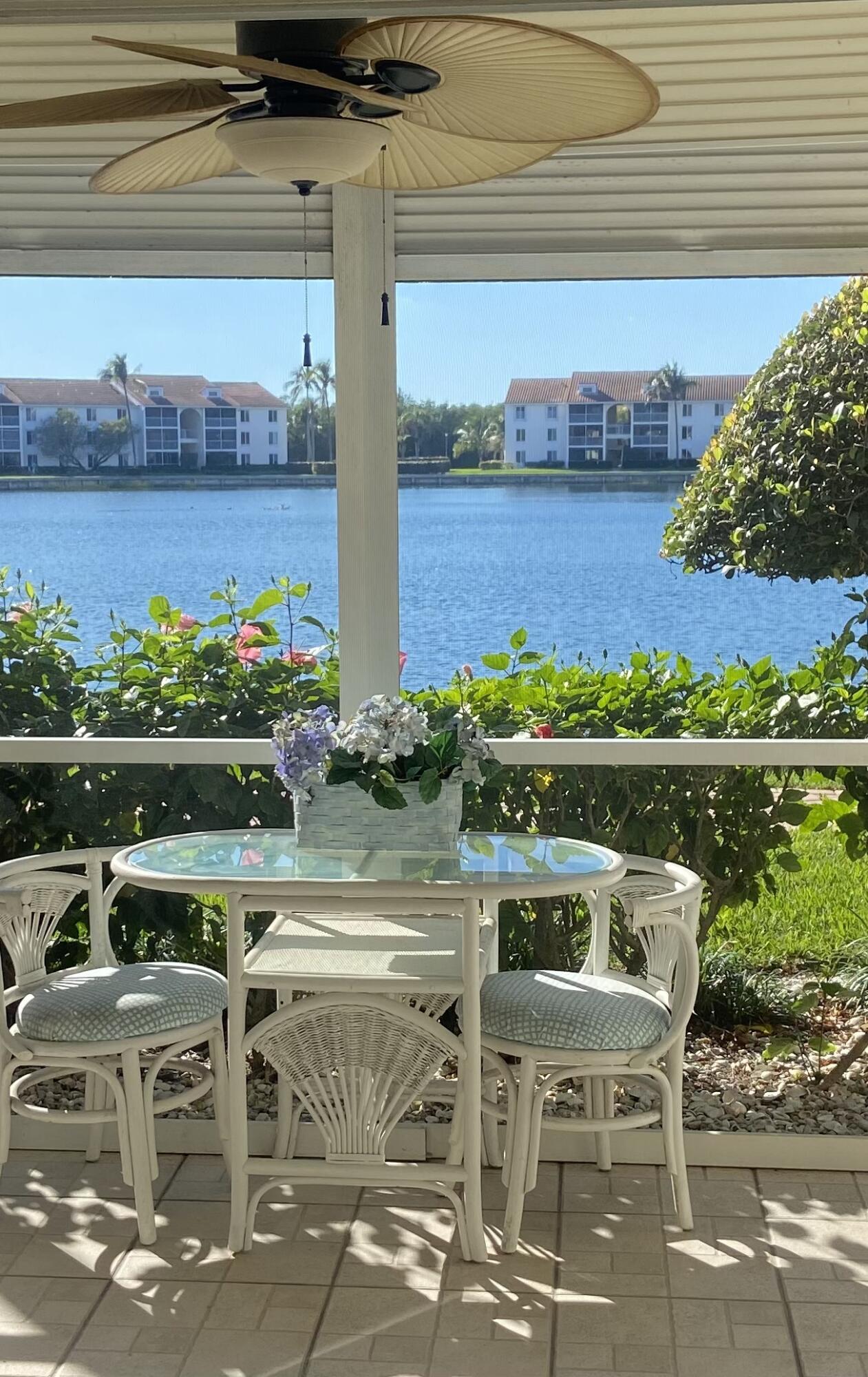 4428 Northeast Ocean Boulevard, Unit G1 Jensen Beach, FL 34957 - Photo 1 of 28 a table and chairs sitting on a terrace