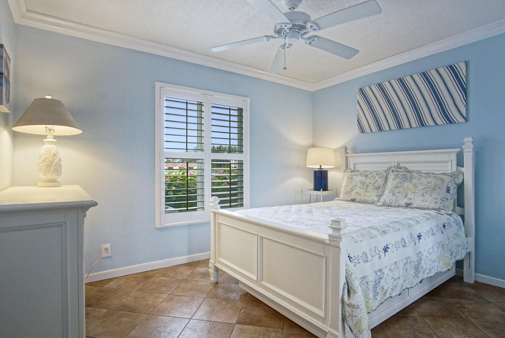 4428 Northeast Ocean Boulevard, Unit G1 Jensen Beach, FL 34957 - Photo 13 of 28 a bedroom with a bed and a chandelier