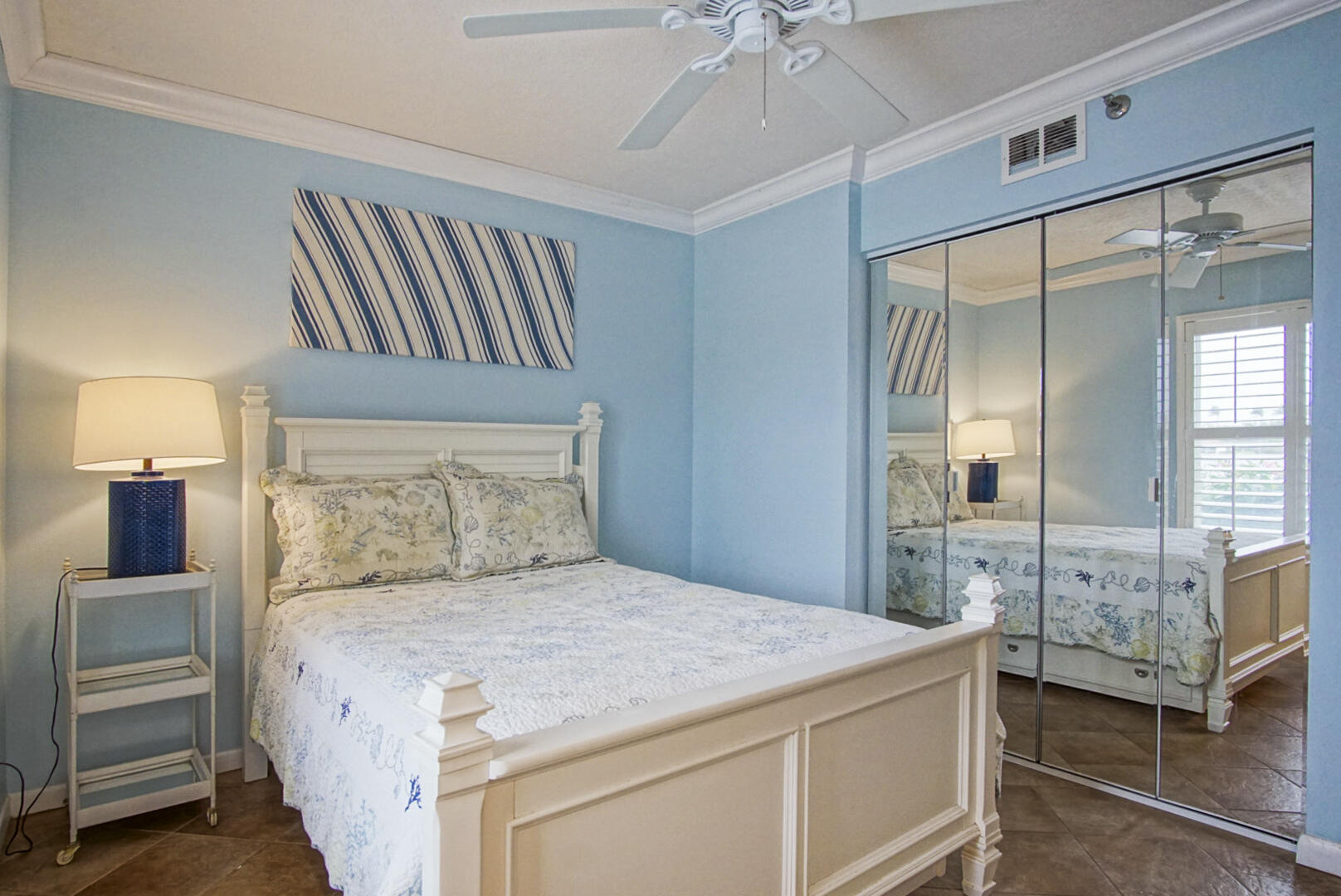 4428 Northeast Ocean Boulevard, Unit G1 Jensen Beach, FL 34957 - Photo 14 of 28 a bedroom with a bed and a chandelier