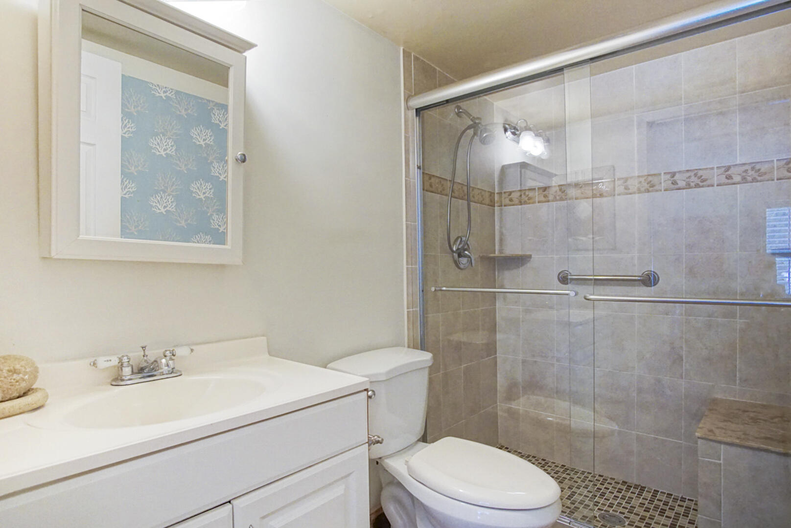 4428 Northeast Ocean Boulevard, Unit G1 Jensen Beach, FL 34957 - Photo 15 of 28 a bathroom with a sink toilet and shower