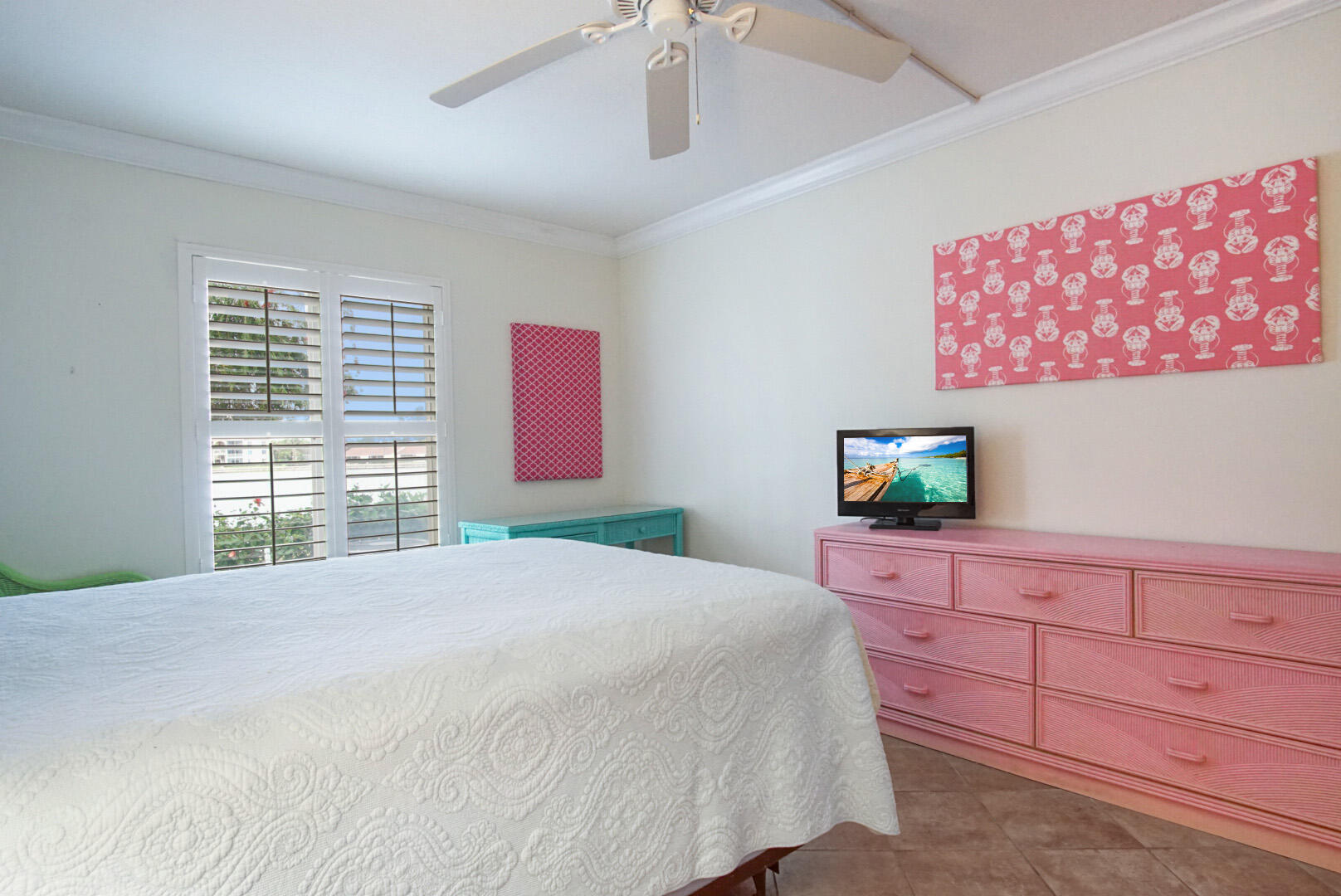 4428 Northeast Ocean Boulevard, Unit G1 Jensen Beach, FL 34957 - Photo 17 of 28 a bedroom with a bed and a flat screen tv