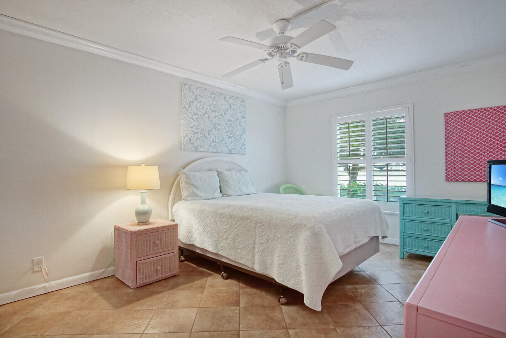4428 Northeast Ocean Boulevard, Unit G1 Jensen Beach, FL 34957 - Photo 18 of 28 a bedroom with a bed and a chandelier
