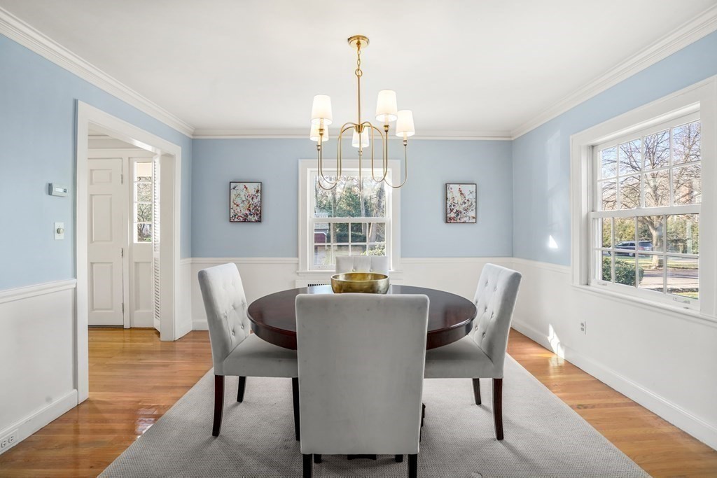 243 Rutledge Road Belmont, MA 02478 - Photo 11 of 21 a dining room with furniture a chandelier and wooden floor