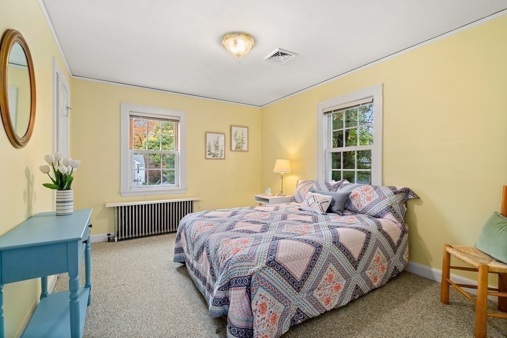 243 Rutledge Road Belmont, MA 02478 - Photo 17 of 21 a bedroom with a bed a dresser and a window