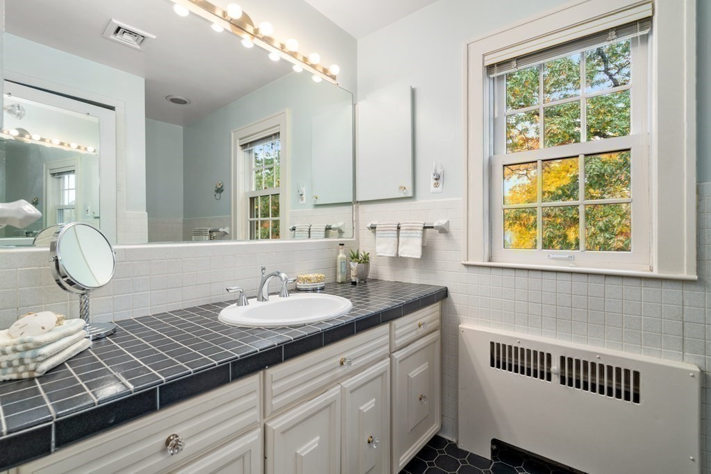 243 Rutledge Road Belmont, MA 02478 - Photo 18 of 21 a bathroom with a granite countertop sink and a mirror