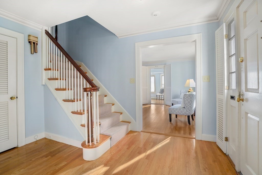 243 Rutledge Road Belmont, MA 02478 - Photo 5 of 21 a view of a hallway with wooden floor and staircase