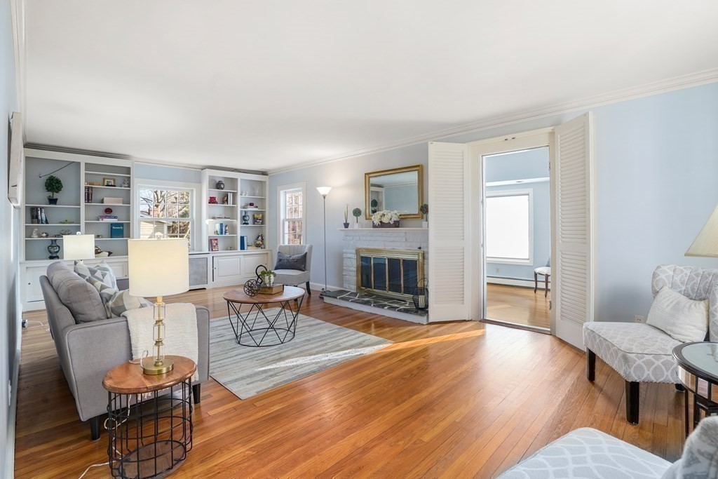 243 Rutledge Road Belmont, MA 02478 - Photo 6 of 21 a living room with fireplace furniture and a wooden floor