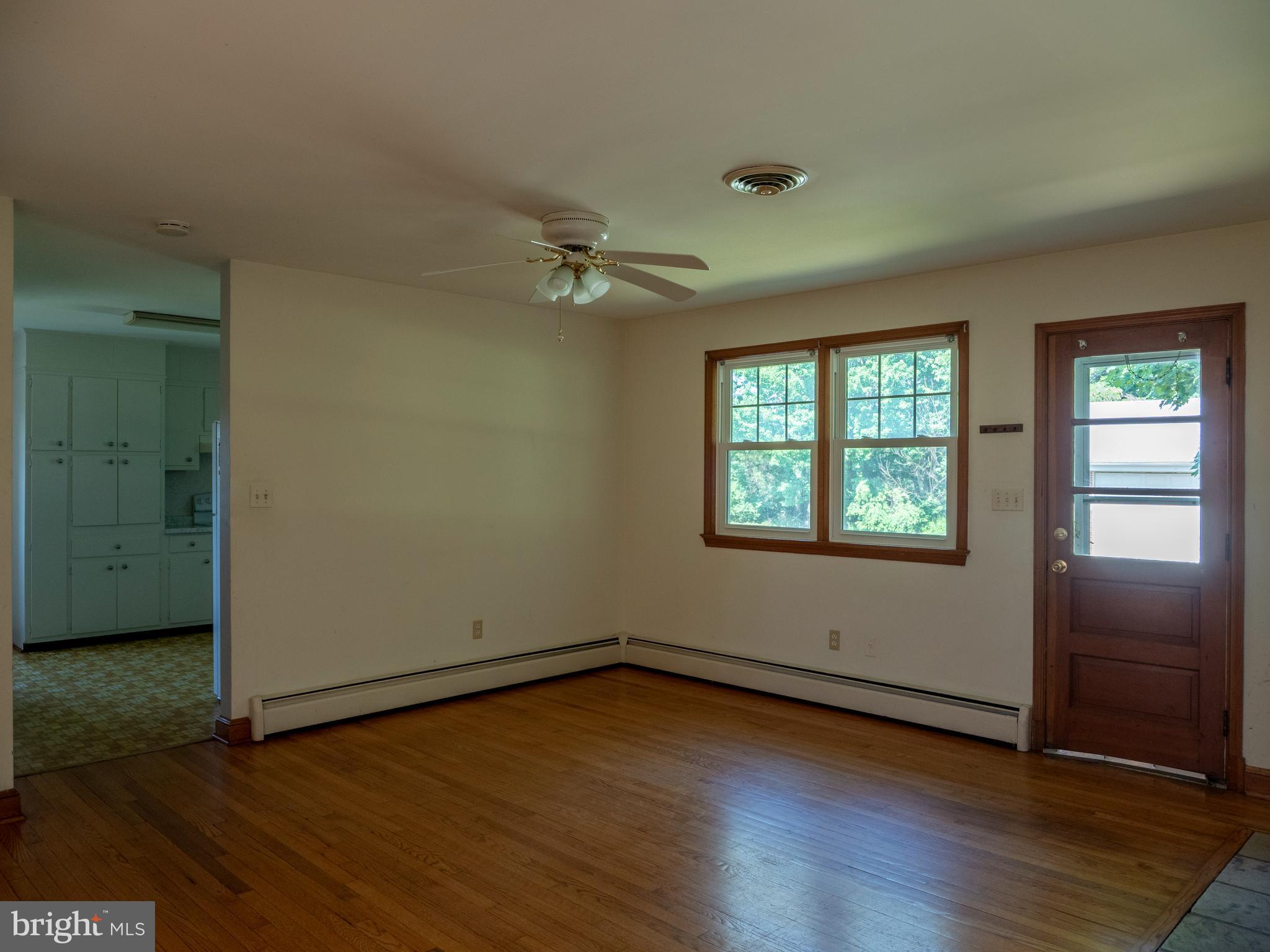 26906 Clarksburg Road Damascus, MD 20872 - Photo 6 of 17 an empty room with wooden floor and windows
