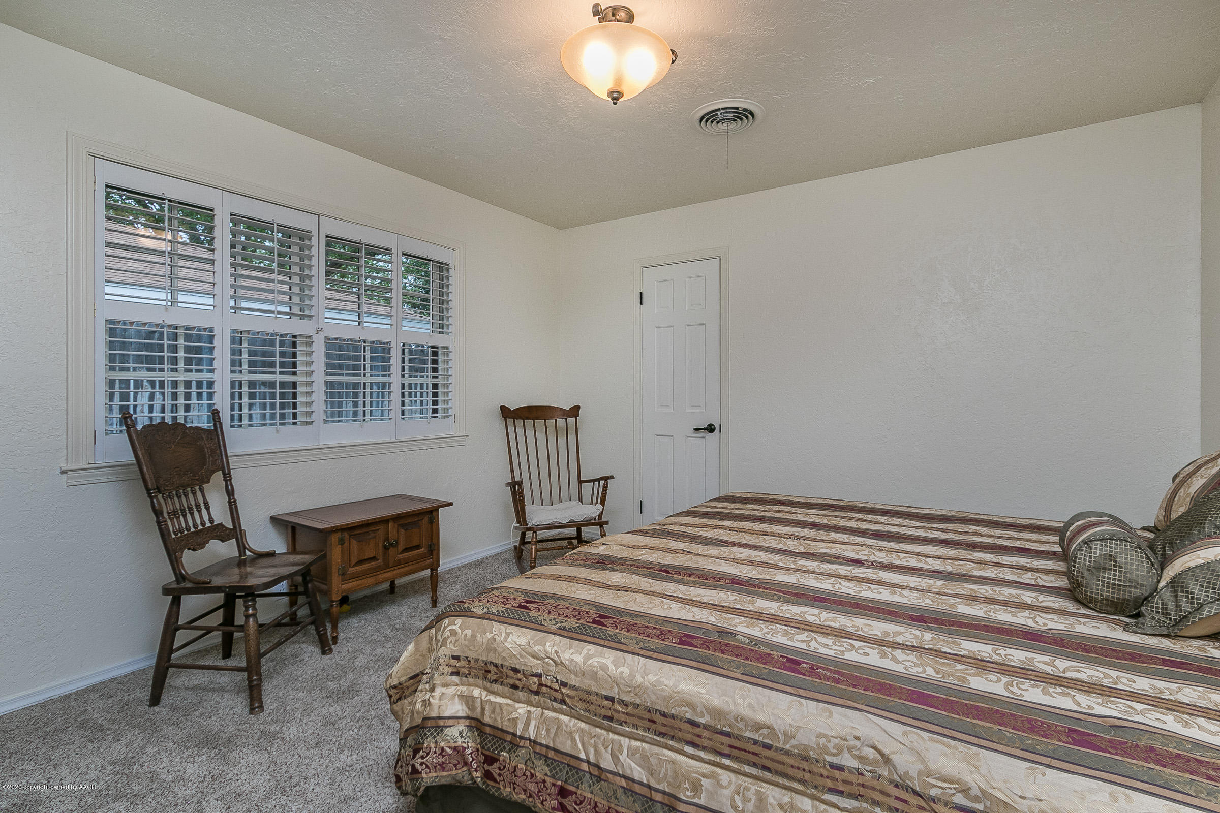 6906 Elmhurst Road Amarillo, TX 79106 - Photo 25 of 33 a bedroom with bed and a window