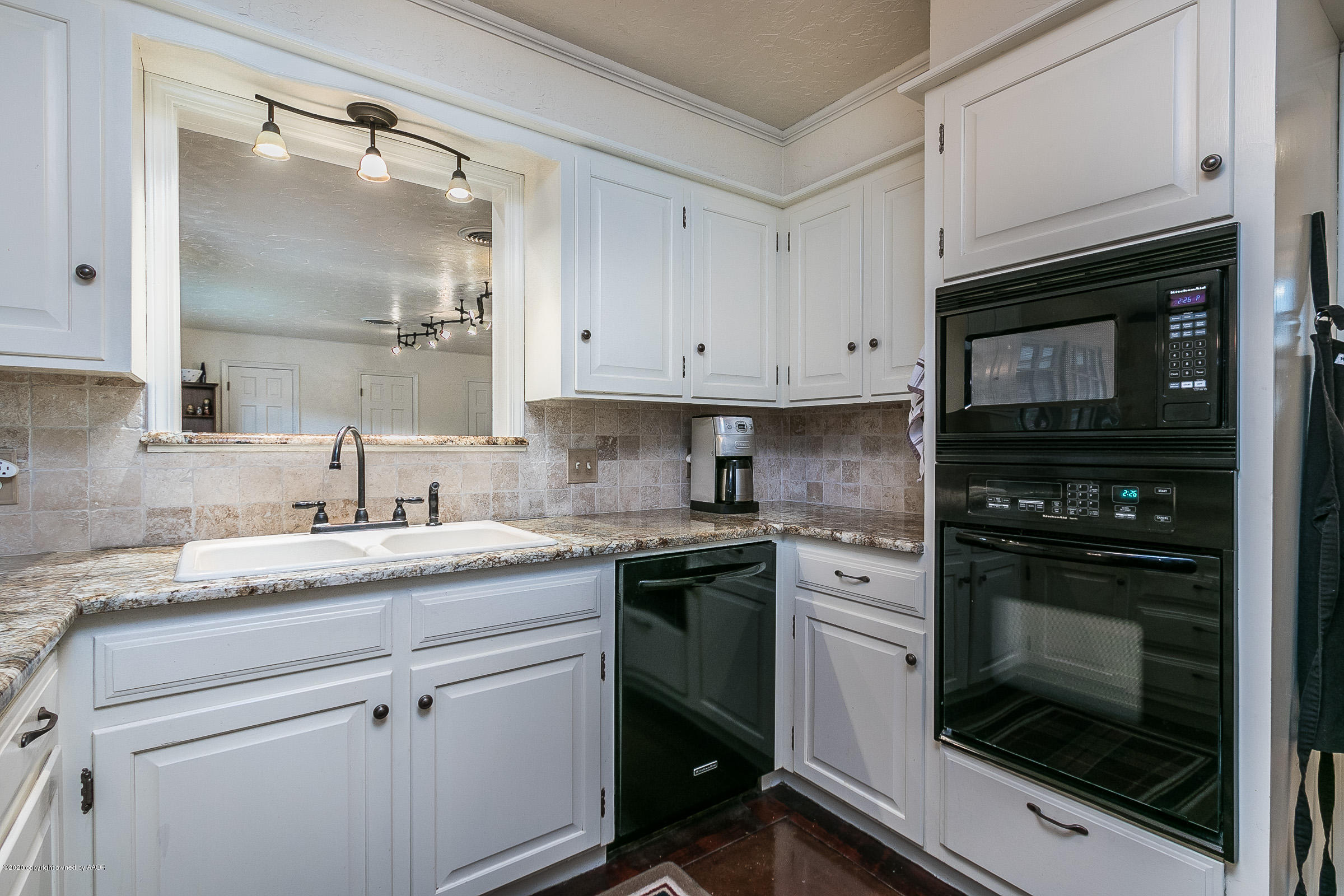 6906 Elmhurst Road Amarillo, TX 79106 - Photo 8 of 33 a kitchen with cabinets stainless steel appliances and a sink