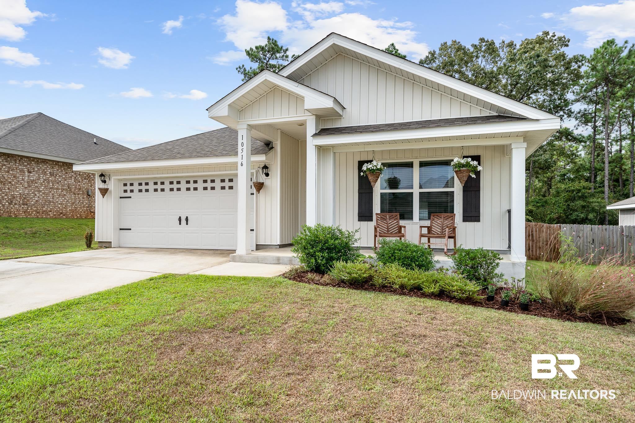 10516 Brodick Loop Daphne, AL 36527 - Photo 2 of 27 View of front facade with covered porch, a front yard, and a garage