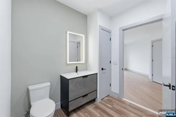 a bathroom with a toilet a sink and mirror
