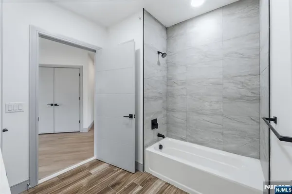 a bathroom with a bathtub and a shower