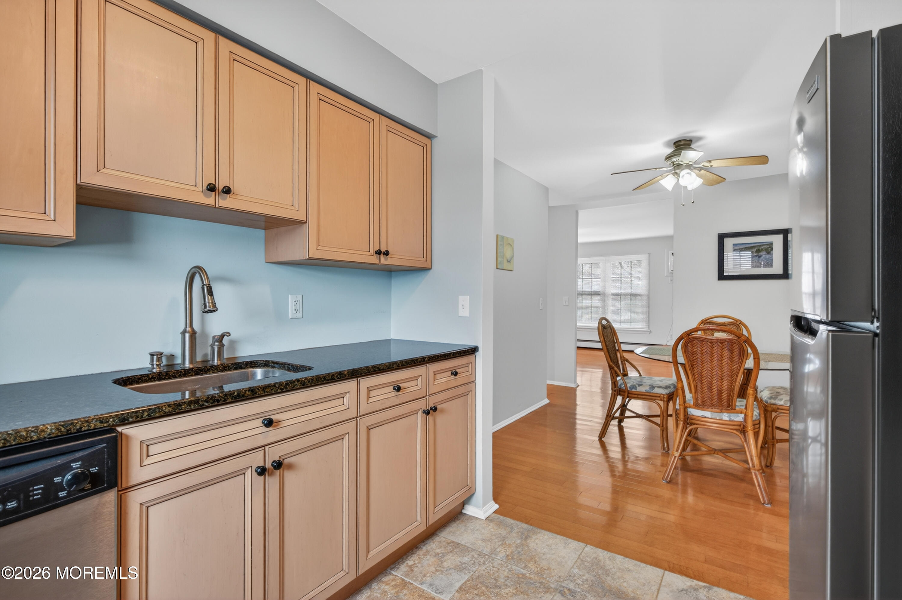 330 Highway 35, Unit 20 Point Pleasant Beach, NJ 08742 - Photo 13 of 22 a kitchen with stainless steel appliances granite countertop a stove a sink dishwasher and white cabinets with wooden floor