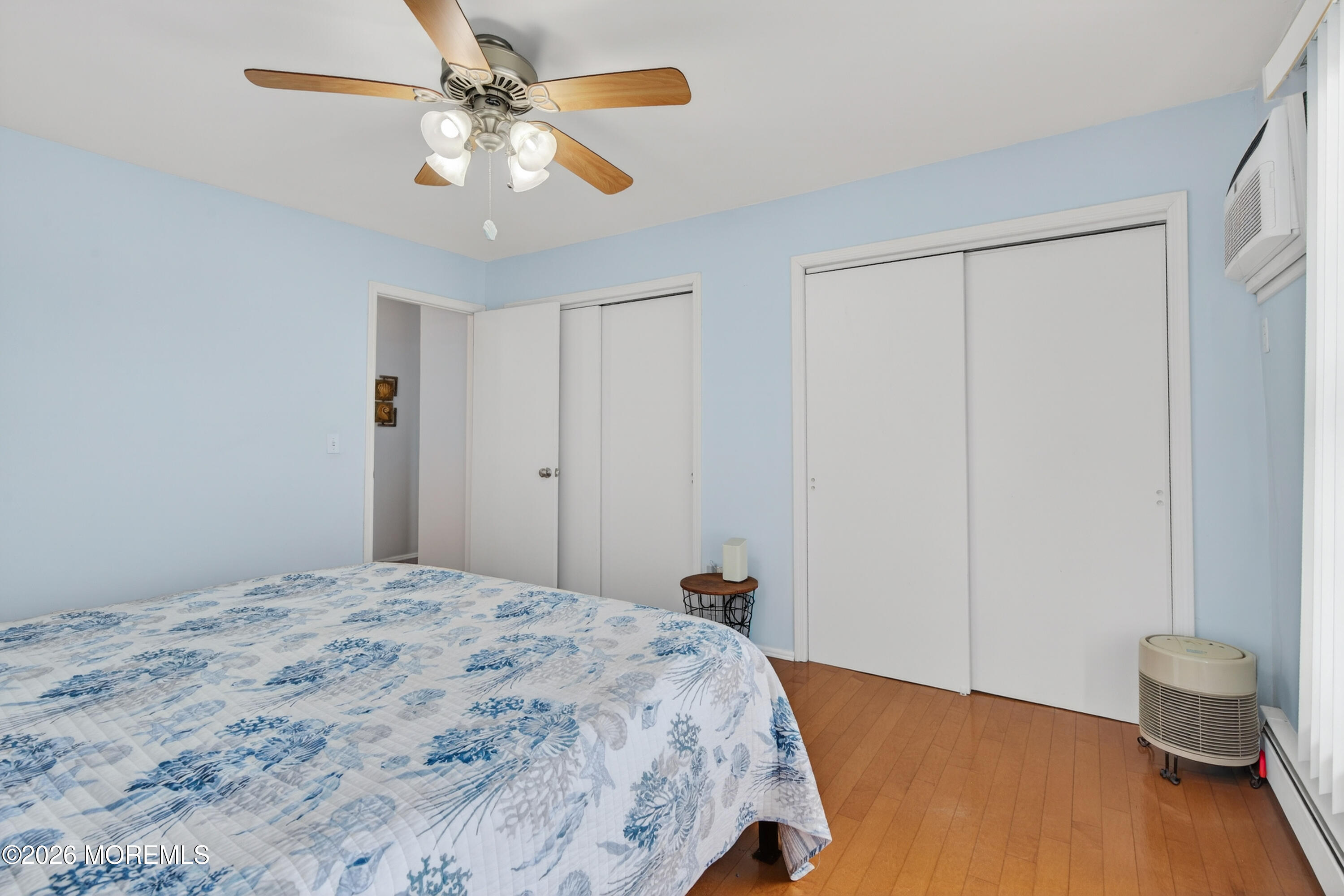 330 Highway 35, Unit 20 Point Pleasant Beach, NJ 08742 - Photo 15 of 22 a bedroom with a bed and a chandelier