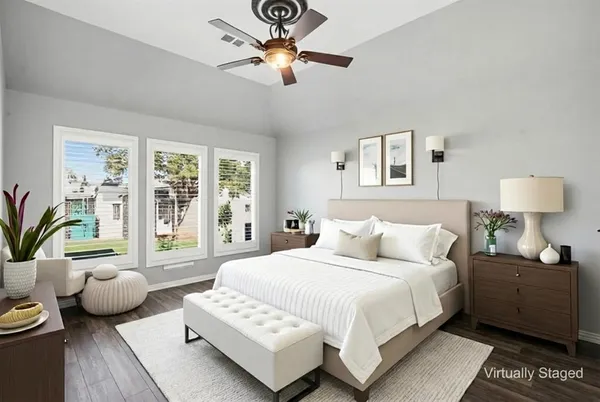 a bedroom with furniture and a large window