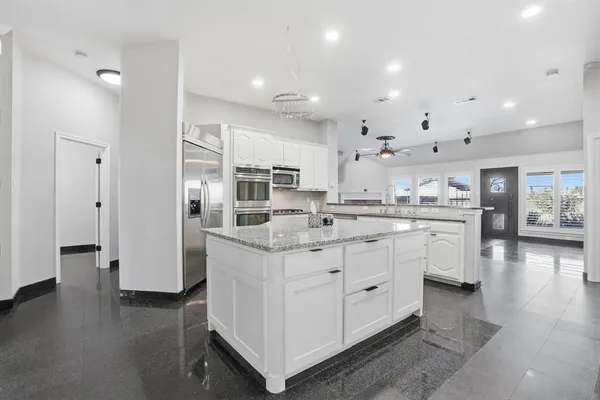 a swimming pool with outdoor seating and yard in the back