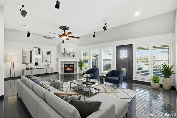 a view of an empty room with a fireplace and a window