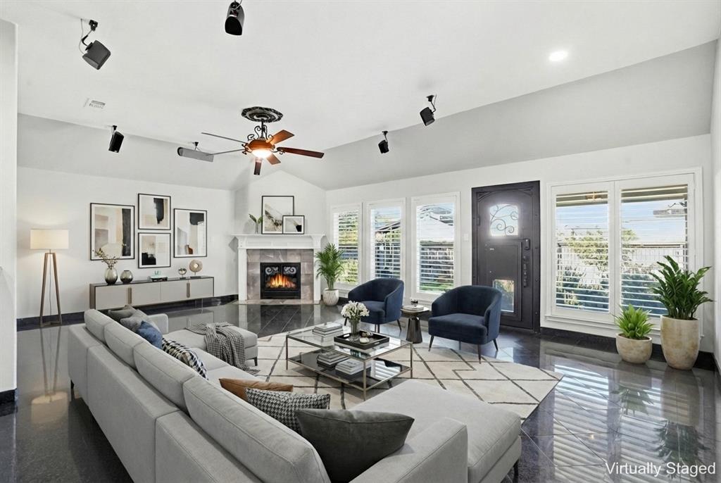 12701 Beech Tree Lane Fort Worth, TX 76040 - Photo 25 of 33 a living room with furniture a fireplace and a chandelier