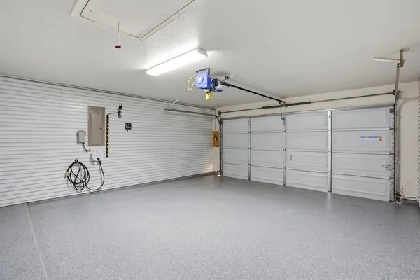 an empty room with large window and wooden floor